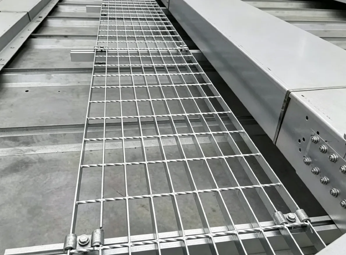 Installed bar grating panels on an industrial access structure.